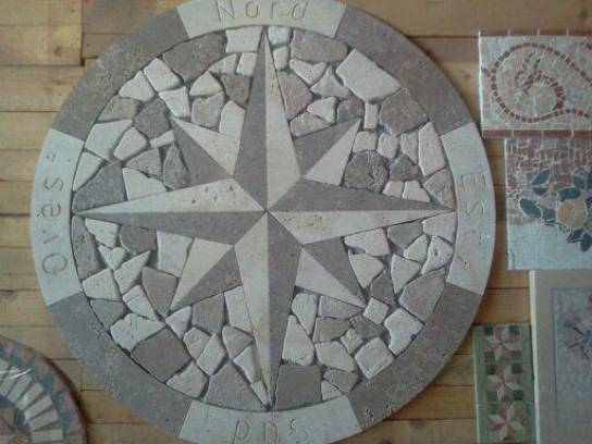 Rose of winds:travertine and pebbles.